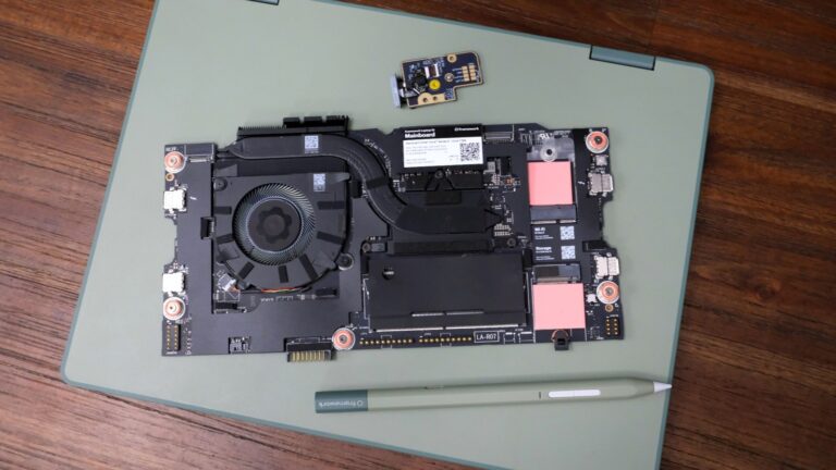 Framework Laptop 12 on a table, on top of which is the new mainboard, fingerprint reader and stylus.